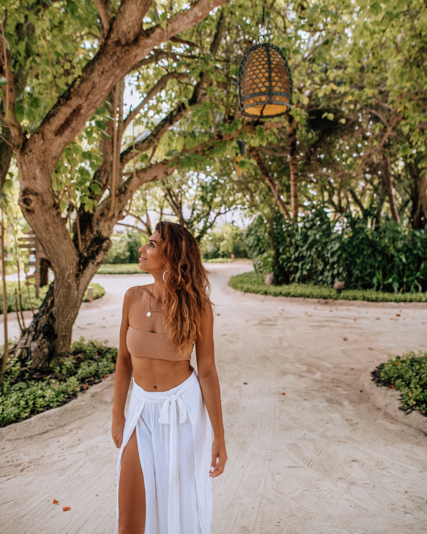 Woman walking around Anantara Dhigu Resort in the Maldives