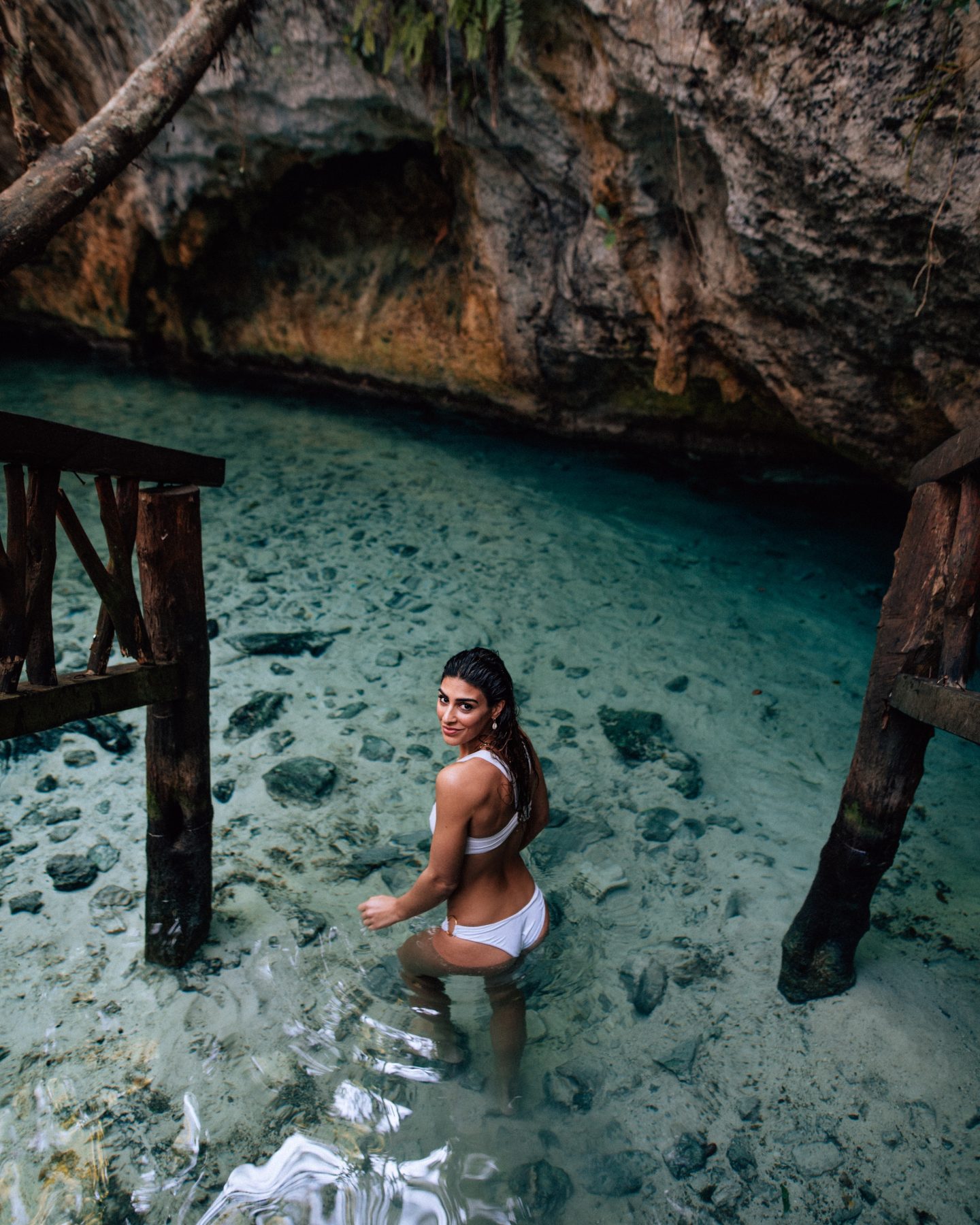 A woman in a white bikini at Grande Cenote in Tulum Mexico