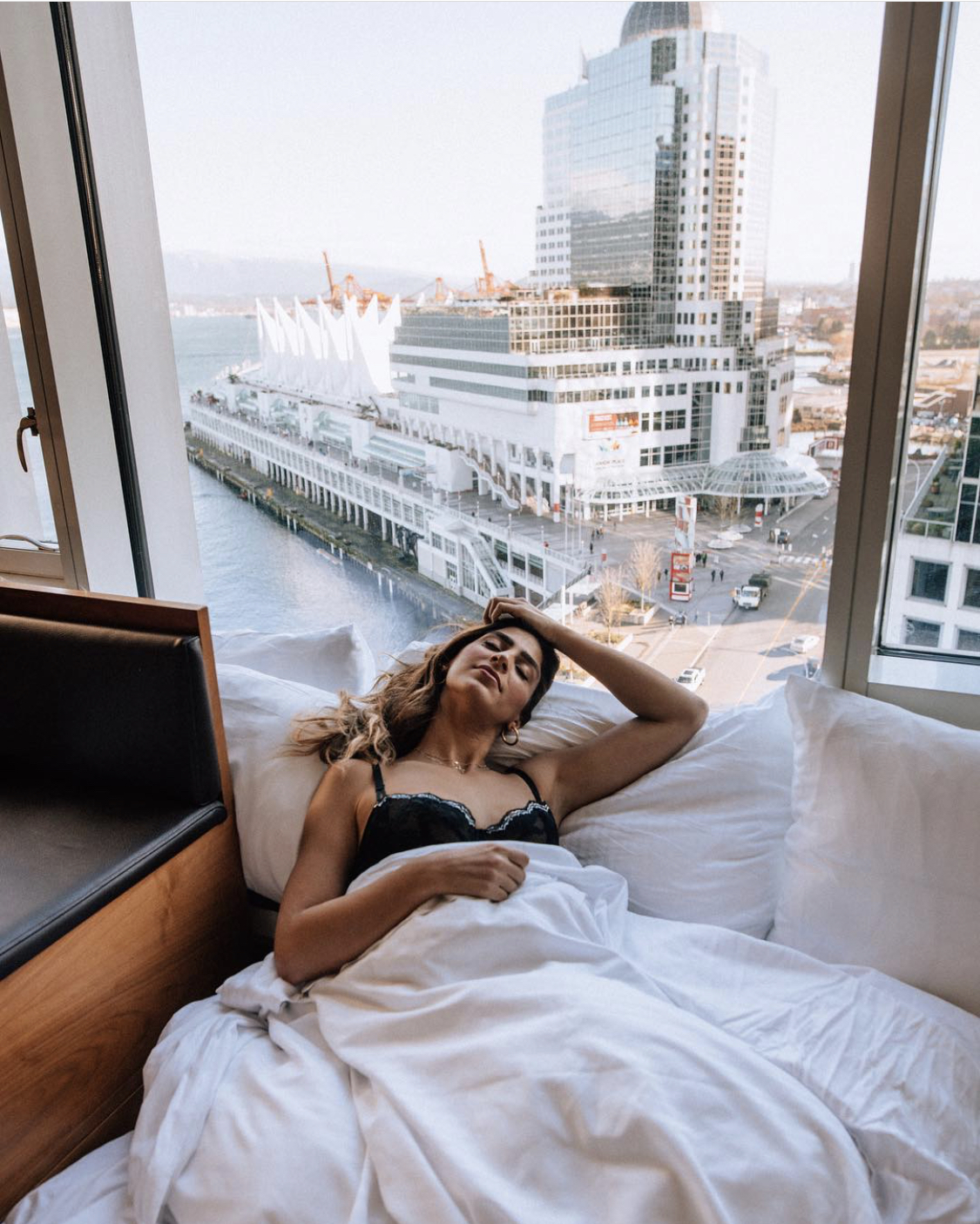 Woman waking up in a hotel in Vancouver, Canada