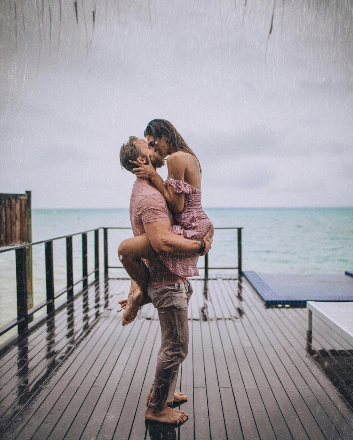 Couple recreating The Notebook kiss in the rain in the Maldives