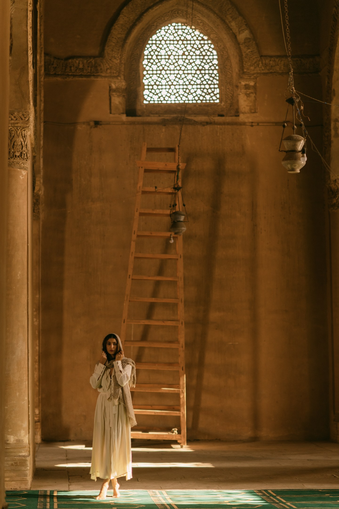 Lisa Homsy walks through Ibn Tulun Mosque in Cairo as the light leaks through the window