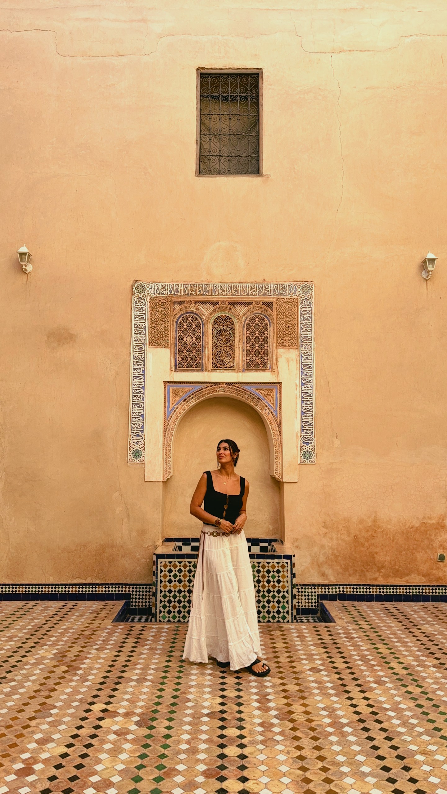 Girl wandering the empty rooms in Marrakech's Bahia Palace
