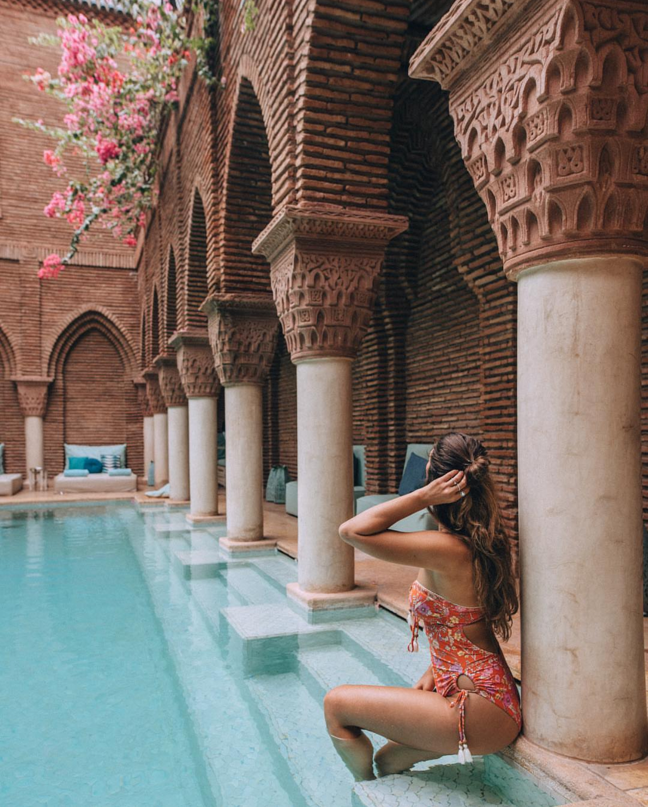 Girl posing looking at the pool at La Sultana in Marrakech, Morocco